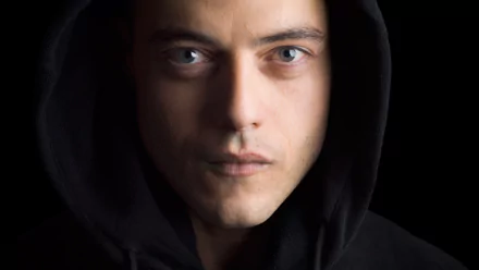 Close-up HD PC desktop wallpaper of the TV show Mr. Robot featuring the main character wearing a black hooded jacket against a dark background.
