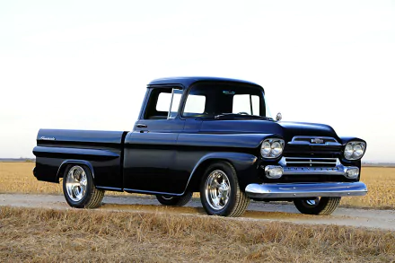A sleek black 1959 Chevrolet Apache hot rod truck parked on a rural road, captured in HD for a PC desktop wallpaper and background.