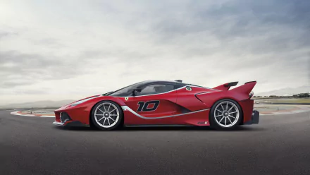 HD PC desktop wallpaper featuring a sleek red Ferrari FXX K race car on a racetrack under a cloudy sky.