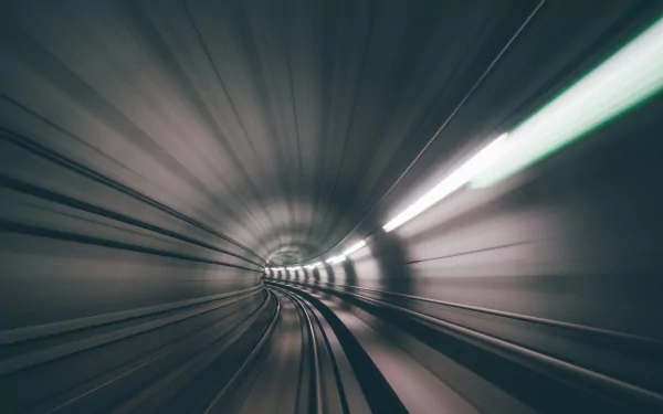 HD desktop wallpaper featuring a man-made tunnel with motion blur effects, creating a dynamic sense of speed and depth.