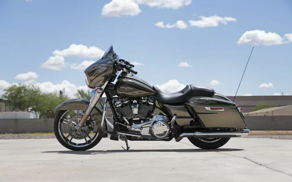 Harley-Davidson Electra Glide Ultra Classic parked on sunlit pavement beneath a blue sky — HD PC desktop wallpaper.