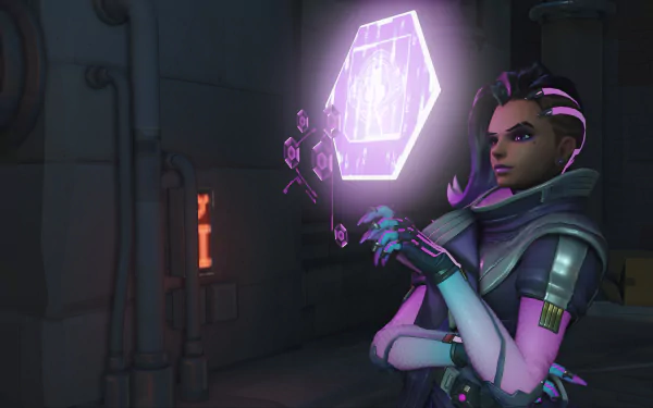 Sombra from Overwatch stands confidently, holding a glowing purple hexagon, set against a dark, industrial background. This HD PC desktop wallpaper showcases the game's striking visuals.