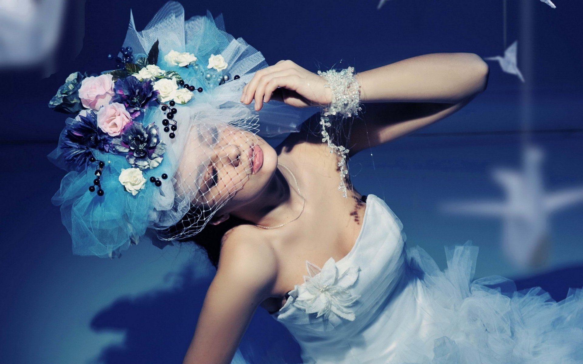 A bride in a white dress and veil adorned with flowers poses gracefully against a dark background in this HD PC desktop wallpaper.