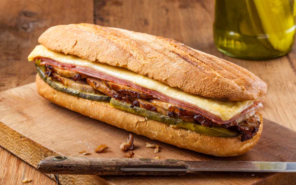 4K Ultra HD image of a gourmet sandwich with melted cheese and grilled vegetables on a wooden board, set against a rustic background.