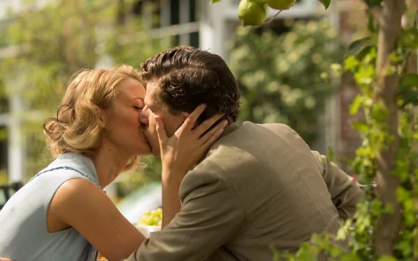 HD PC desktop wallpaper featuring Blake Lively and Jesse Eisenberg sharing a kiss in a garden scene from the movie Cafe Society.