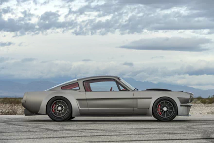 HD wallpaper of a sleek Ford Mustang Fastback muscle car hot rod parked on an open road under a cloudy sky, showcasing its classic vehicle design and sporty stance.