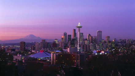 HD wallpaper featuring the Seattle skyline at dusk with the Space Needle prominent against a purple sky and Mount Rainier in the background.