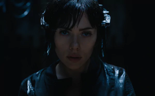 Scarlett Johansson as the Major in Ghost in the Shell (2017). The image is a dark, intense HD desktop wallpaper featuring her face under a futuristic headgear from the movie.