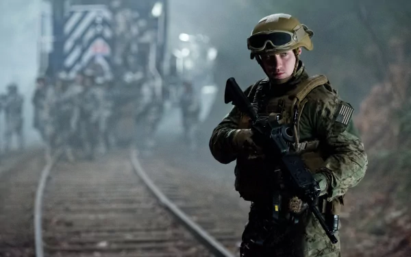 4K Ultra HD wallpaper featuring a soldier from the 2014 Godzilla movie, standing alert near railroad tracks with a blurred military convoy in the background.