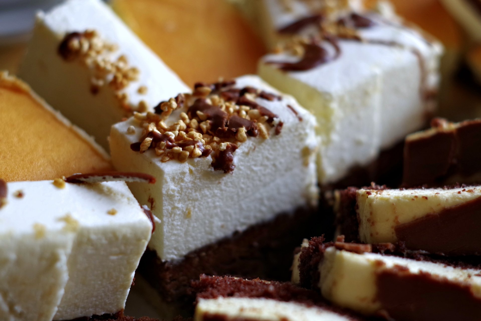 Close-up of food: assorted creamy sweets and layered dessert bars, high-detail 4K Ultra HD PC desktop wallpaper background.