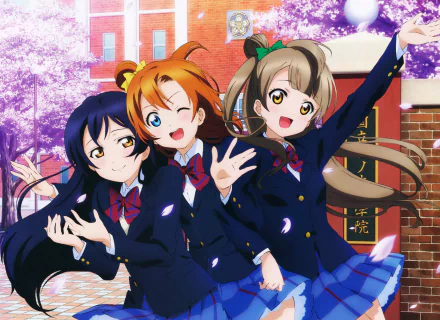 HD desktop wallpaper featuring Umi Sonoda, Honoka Kousaka, and Kotori Minami from the anime Love Live!, posing cheerfully in their school uniforms amid a background of cherry blossoms.