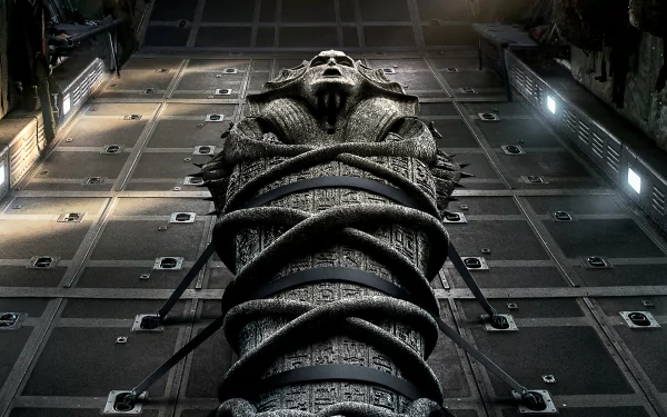 HD wallpaper from the movie The Mummy (2017) featuring a detailed sarcophagus strapped with chains in a dimly lit, futuristic setting.