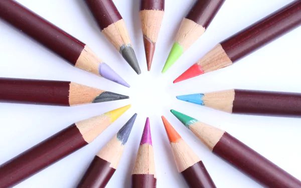 Sharpened colored pencils arranged in a radial circle on white background — color photography presented as a 5K Ultra HD PC desktop wallpaper and background.