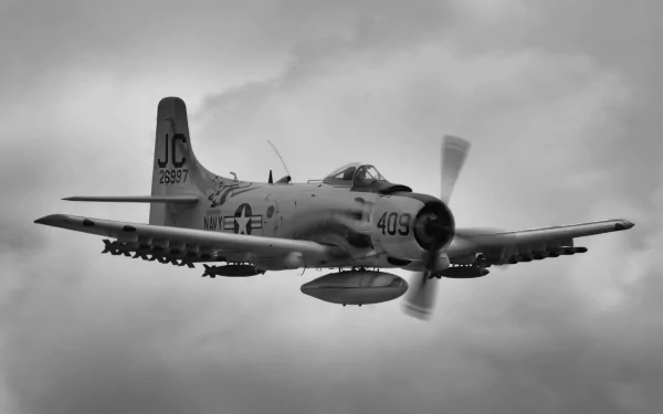 HD PC desktop wallpaper/background: Navy Douglas A-1 Skyraider warplane in flight — military aircraft with underwing ordnance against a moody cloudy sky.