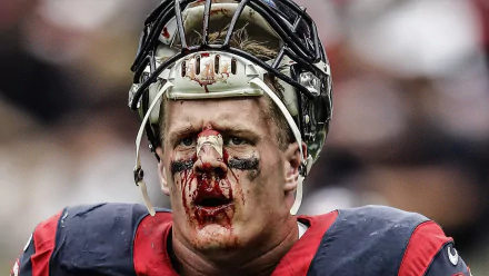 HD wallpaper of a football player in a helmet with face paint, evoking J.J. Watt's intensity on the field.