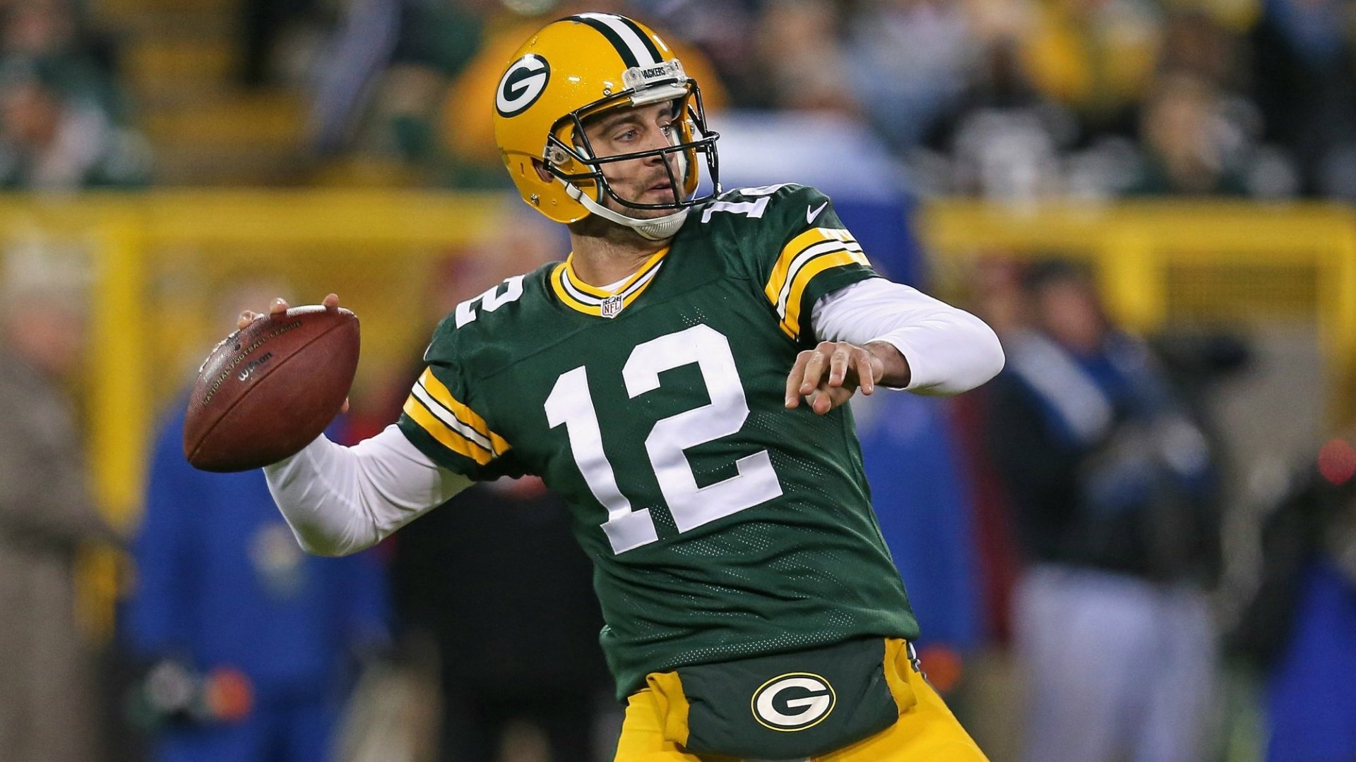 HD wallpaper of a Green Bay Packers quarterback in action, wearing #12, set against a stadium backdrop.