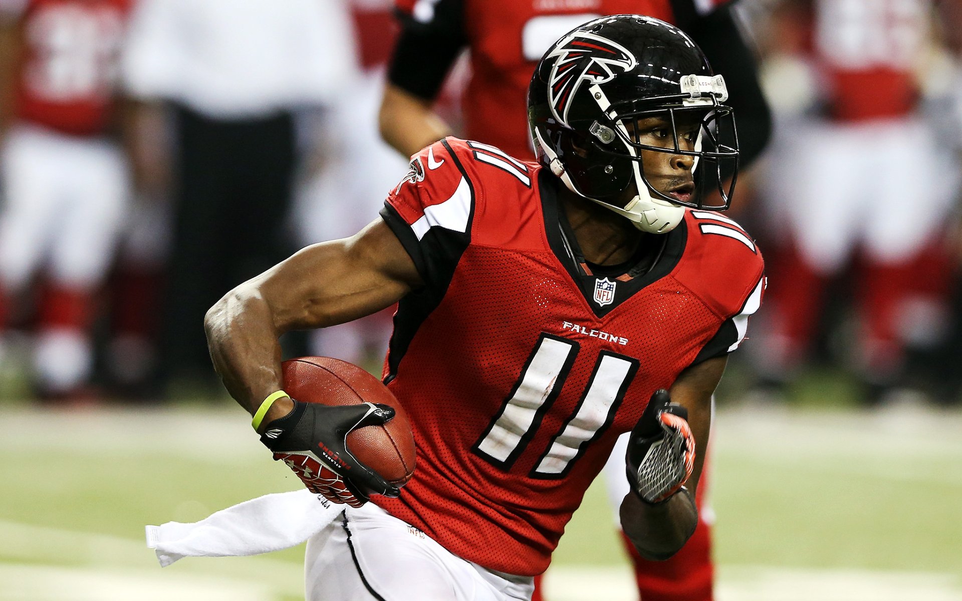 HD desktop wallpaper featuring Julio Jones in a red Falcons jersey running with a football.