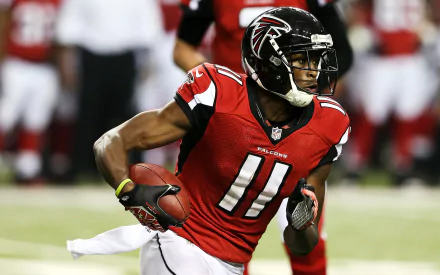 HD desktop wallpaper featuring Julio Jones in a red Falcons jersey running with a football.