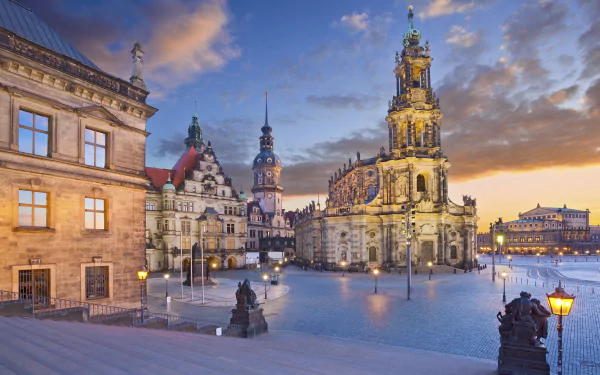 HD desktop wallpaper of Dresden, Germany, featuring stunning architecture lit up at night against a vibrant evening sky. Theaters and historic buildings enhance the city's cultural charm.