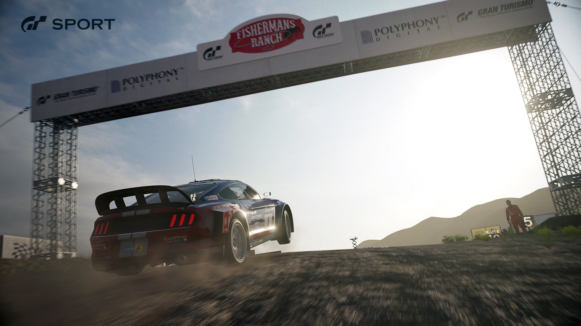 HD PC desktop wallpaper featuring a Ford car racing under a bridge in the Gran Turismo Sport video game, showcasing dynamic action and detailed graphics.