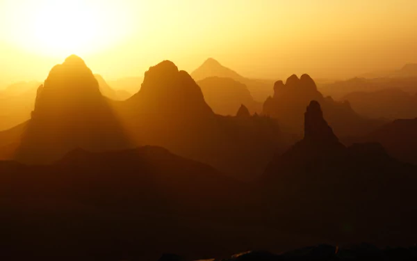 Sunset over the rugged Hoggar Mountains in Tassili N'Ajjer, Assekrem, Algeria, showcasing the natural beauty of this African landscape in 4K Ultra HD.