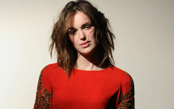 Stylish celebrity portrait of a woman in a red dress with tousled hair against a pale backdrop — 4K Ultra HD PC desktop wallpaper.