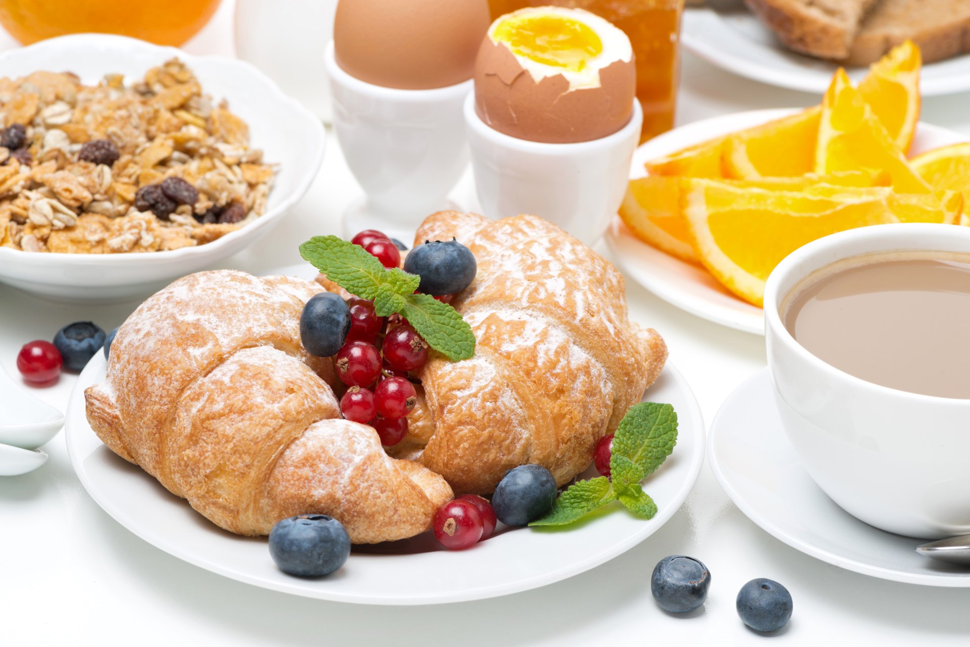8K Ultra HD PC desktop wallpaper - a still-life breakfast: powdered croissant with currants and blueberries, soft-boiled egg, coffee, granola and orange slices