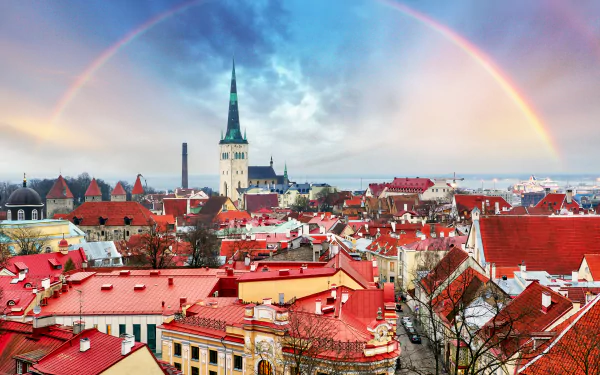 4K Ultra HD cityscape of Tallinn, Estonia, showcasing historic architecture and red rooftops under a vibrant rainbow in the sky.