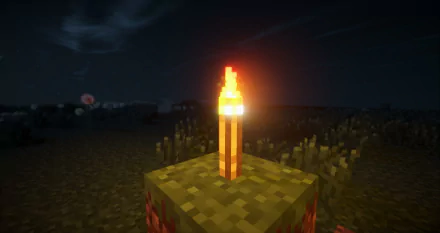 HD Minecraft desktop wallpaper featuring a glowing torch with fire illuminating a blocky grass terrain under a dark night sky.