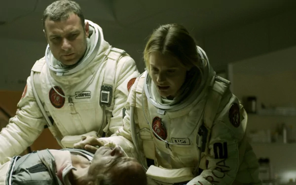 Scene from the movie The Last Days On Mars showing two astronauts in white suits attending to a fallen comrade, captured as an HD PC desktop wallpaper background.