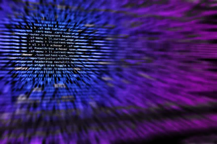 HD desktop wallpaper featuring blurred lines of programming code in blue and purple hues, creating a dynamic and technologically advanced background.
