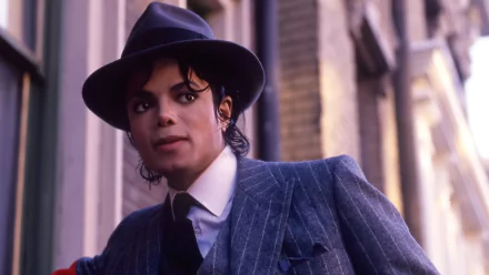 HD desktop wallpaper featuring Michael Jackson in a sharp suit and fedora, standing on a street, evoking his iconic musical style and persona.