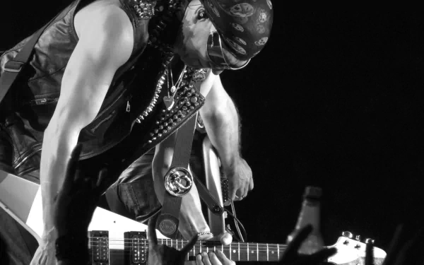 Black and white HD desktop wallpaper of a musician from the band Scorpions, playing a guitar while leaning forward on stage.