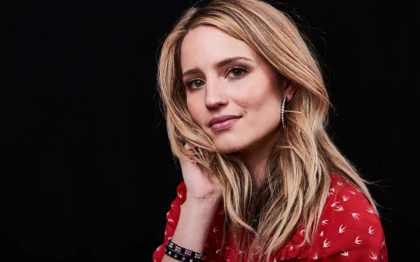 Close-up of American actress Dianna Agron with blonde hair and hazel eyes against a black background, captured in stunning 8K Ultra HD quality.