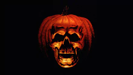 HD PC desktop wallpaper featuring a carved pumpkin with a skull face from the movie Halloween II (1981) against a black background.