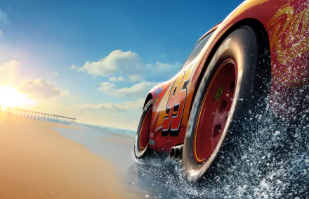 HD desktop wallpaper featuring Lightning McQueen from Pixar's Cars 3, speeding along a beach with splashing water and a beautiful sunset in the background.