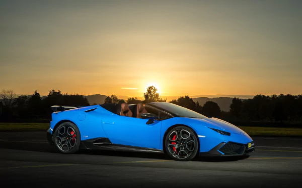 A vibrant blue Lamborghini Huracan supercar captured at sunset, showcased as a stunning 4K Ultra HD PC desktop wallpaper and background.