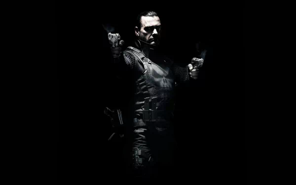 HD PC desktop wallpaper of the movie Punisher: War Zone — the Punisher in tactical armor, dual-wielding pistols, spotlighted against a pitch-black background.