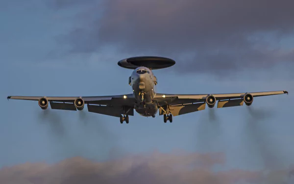 Military Boeing E-3 Sentry aircraft captured mid-flight against a moody sky, presented in stunning 4K Ultra HD quality for PC desktop wallpaper.