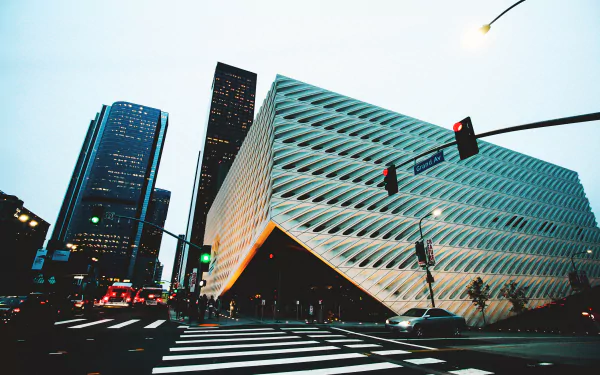A striking cityscape featuring modern skyscrapers and dynamic architecture, showcasing traffic and streetscapes in a vibrant urban environment. HD desktop wallpaper.