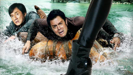 HD desktop wallpaper of a scene from the 2016 movie Skiptrace, directed by Renny Harlin, featuring Jackie Chan and another man struggling in the water with a woman’s boot visible in the foreground.