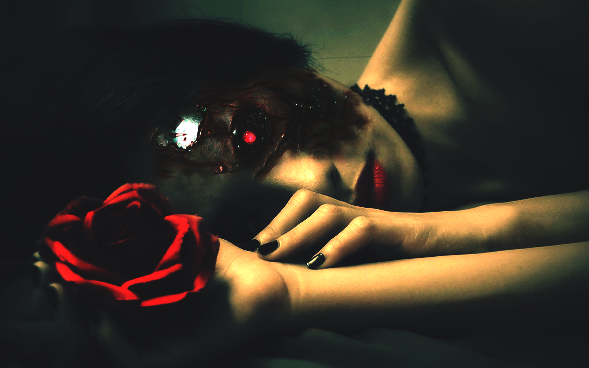 Dark-themed HD desktop wallpaper featuring a woman with red lipstick holding a vibrant red rose in low light.