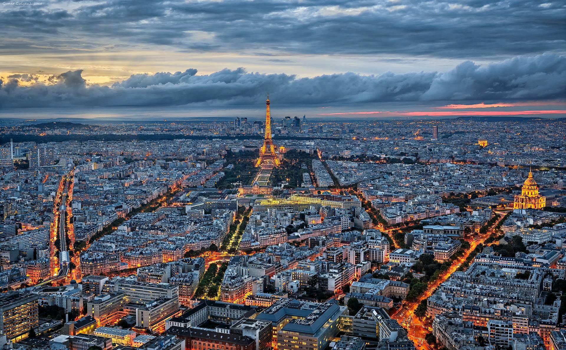 Paris Skyline At Dusk Eiffel Tower Illuminates Cityscape Under Cloudy 