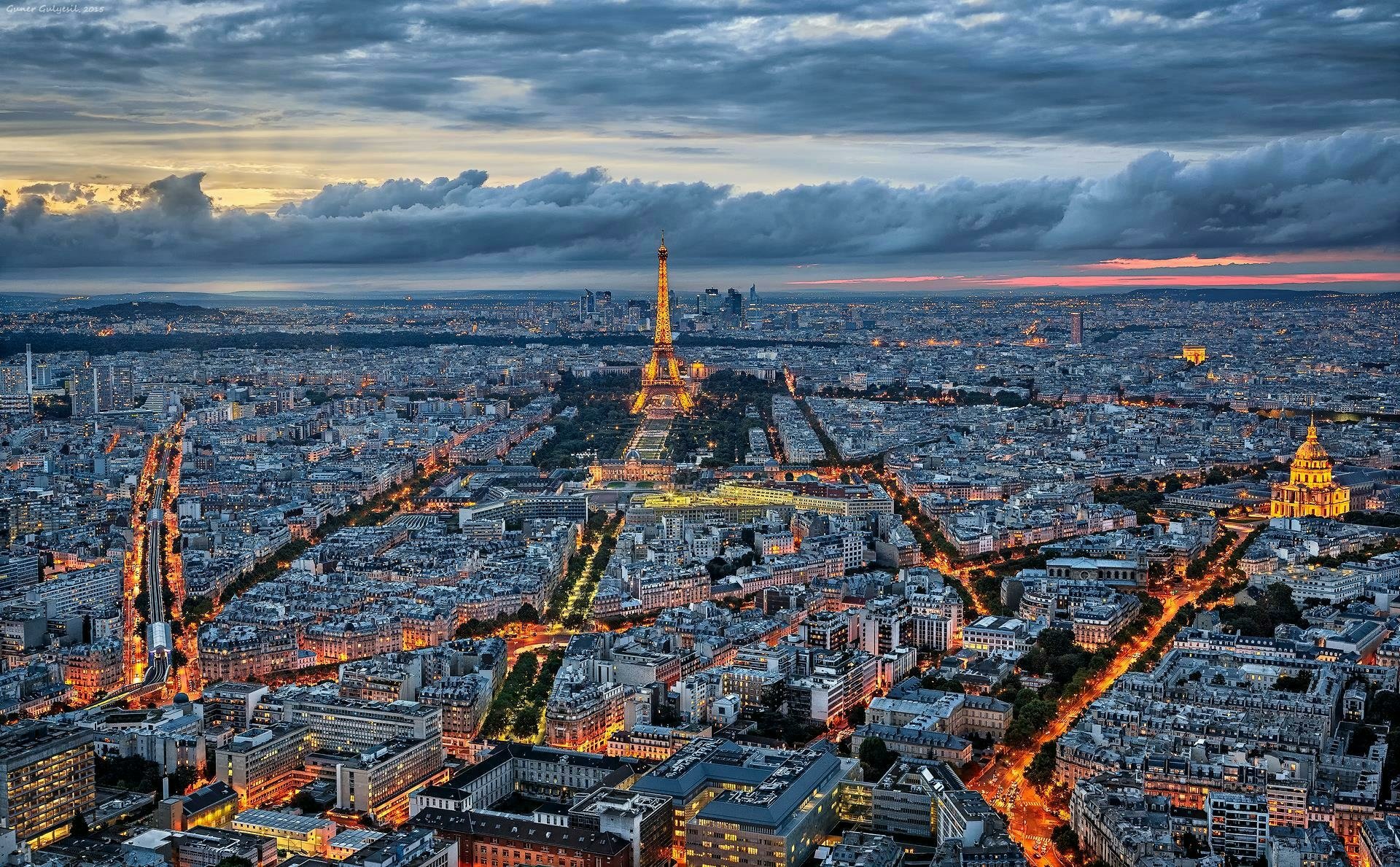 Paris Skyline At Dusk Eiffel Tower Illuminates Cityscape Under Cloudy 