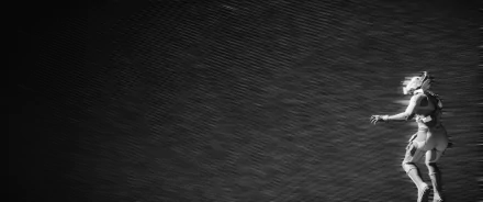 Monochrome 2K Quad HD PC desktop wallpaper: Star Citizen video game astronaut in a space suit drifts at the right edge against a textured cosmic void.