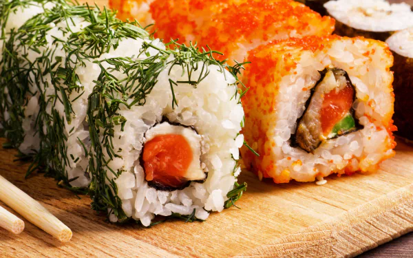 4K Ultra HD PC desktop wallpaper: close-up of assorted sushi rolls—rice, fish and seafood garnished with dill and bright orange roe on a wooden board.