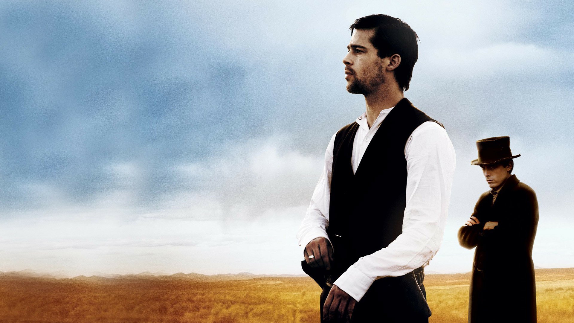 HD PC desktop wallpaper showing two lead actors from the movie The Assassination of Jesse James by the Coward Robert Ford in period western dress on a windswept plain.