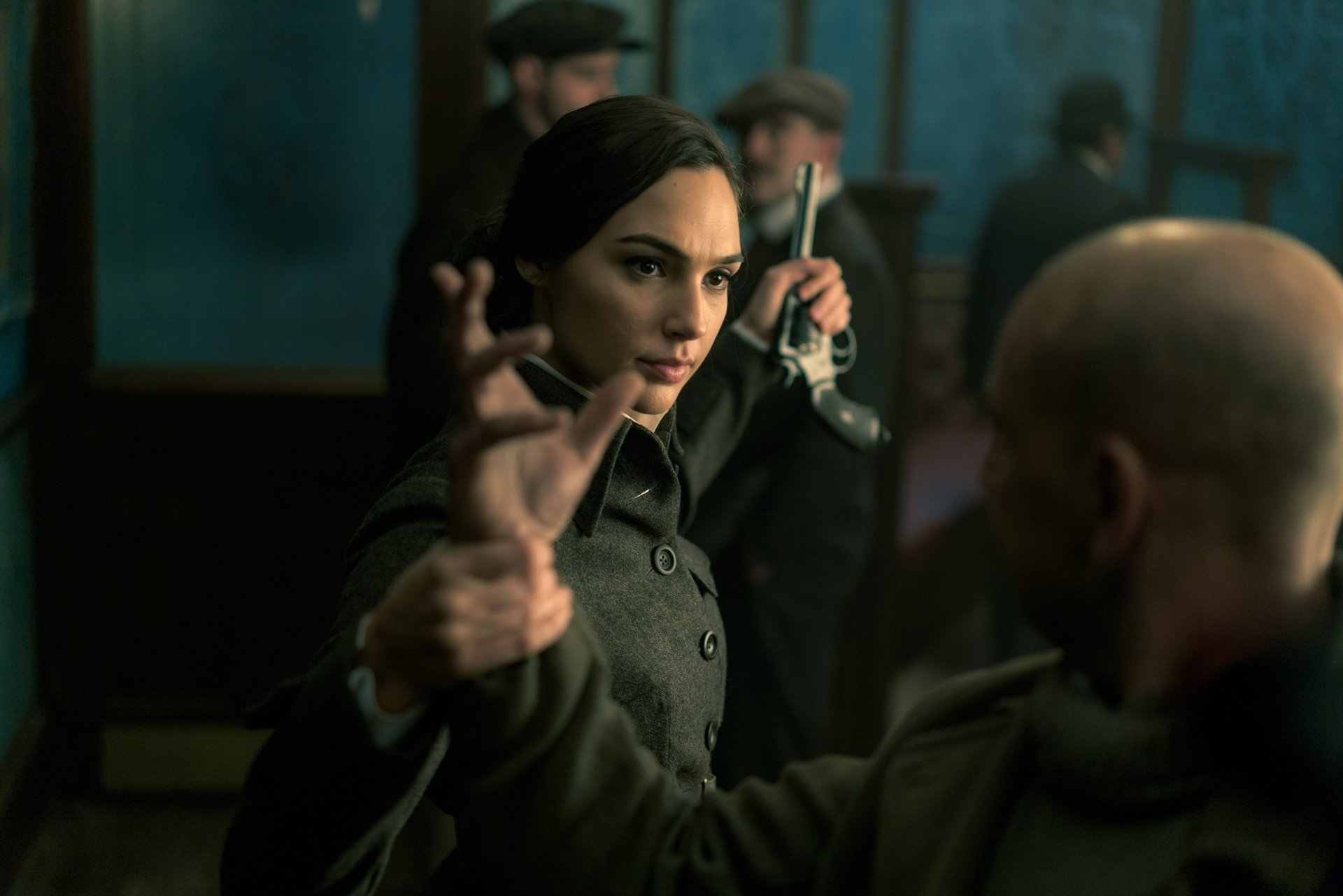 HD desktop wallpaper featuring Gal Gadot as Wonder Woman in a gripping movie scene, showcasing her character's strength and determination in an action-packed environment.