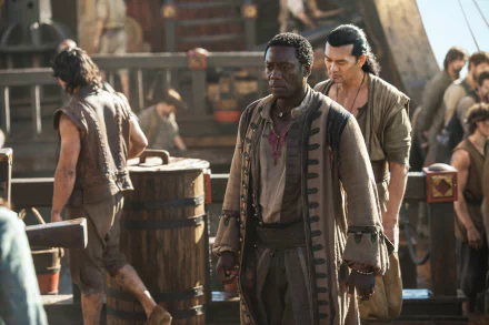 5K Ultra HD Black Sails TV wallpaper: Mr. Scott aboard a crowded pirate ship in a period coat, brooding amid sailors and barrels.