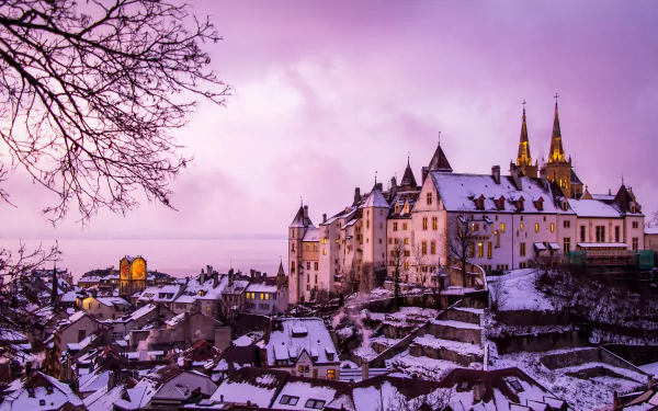 Snow-covered Neuchâtel Castle and cityscape in winter, Switzerland, captured in vibrant 4K Ultra HD with a softly glowing purple sky.